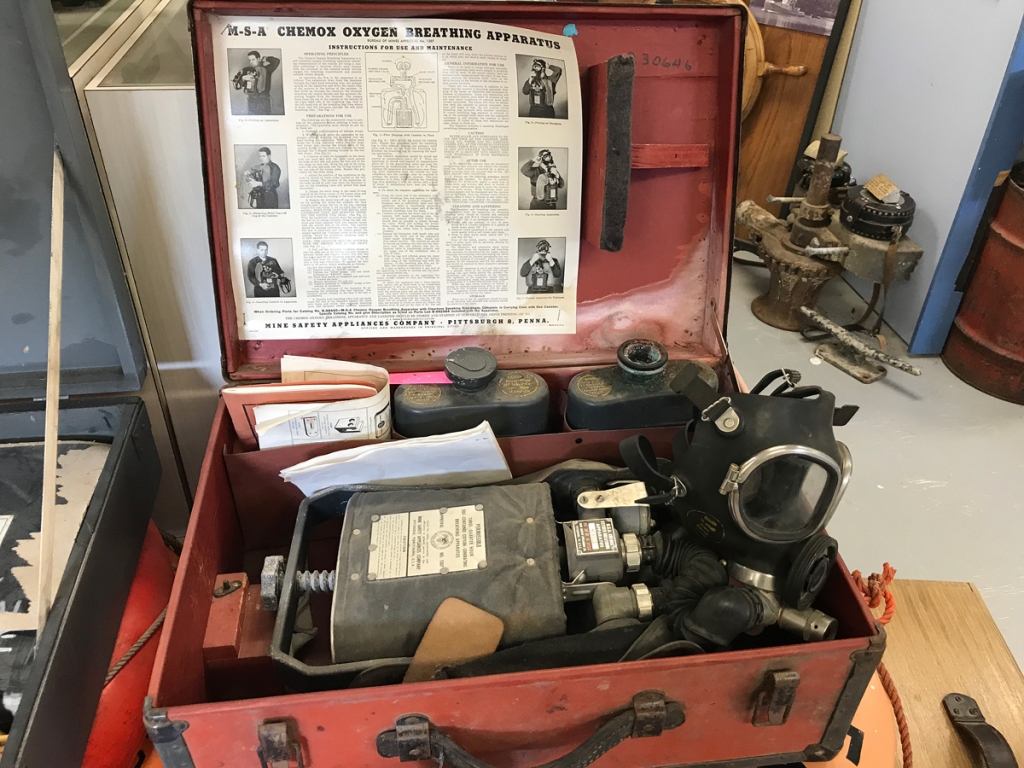A red suitcase contains a "chemox oxygen breathing apparatus" in case of mustard gas attack.